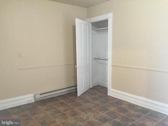 unfurnished bedroom featuring a closet and a baseboard heating unit