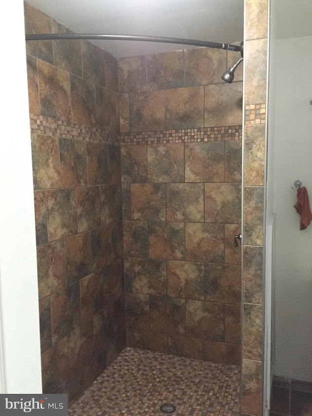 bathroom with tiled shower