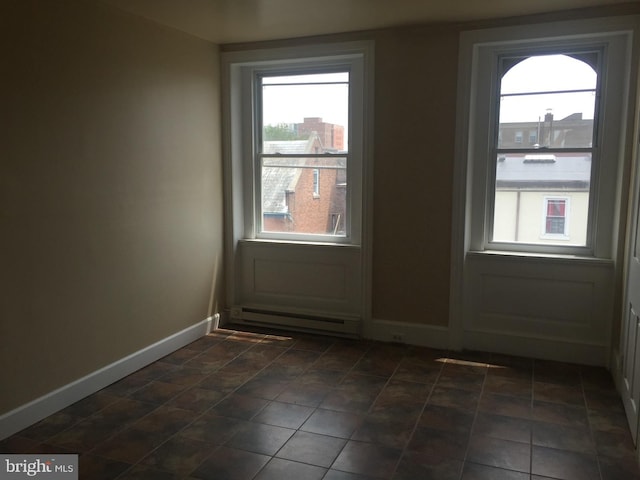 doorway to outside featuring a baseboard heating unit