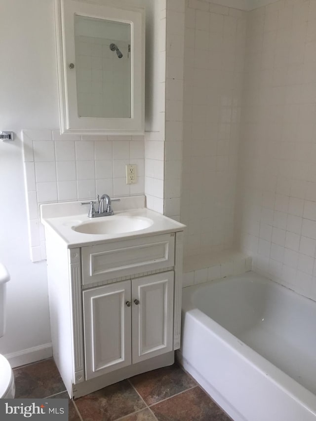 full bathroom with tasteful backsplash, vanity, toilet, and shower / bath combination