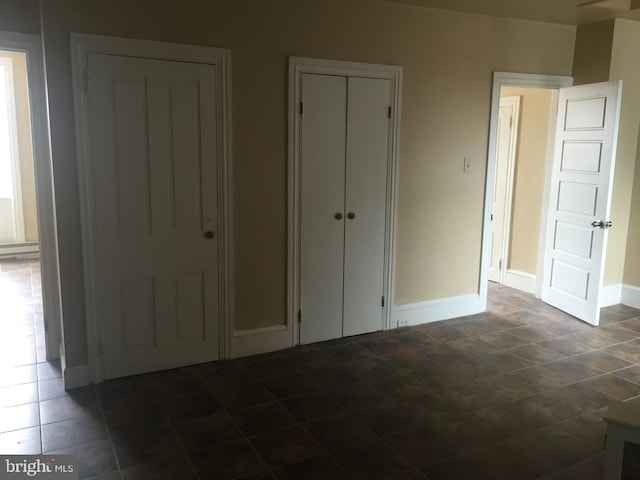 unfurnished bedroom featuring two closets