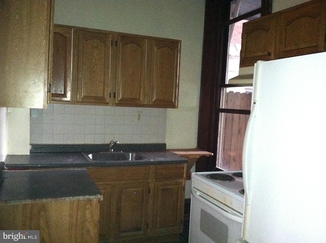 kitchen with white appliances, sink, and decorative backsplash