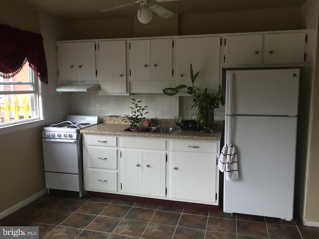 kitchen with sink, white cabinets, decorative backsplash, ceiling fan, and white appliances