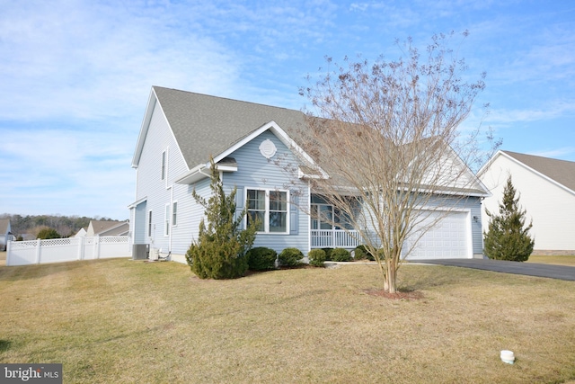 view of front facade with cooling unit, a garage, and a front lawn