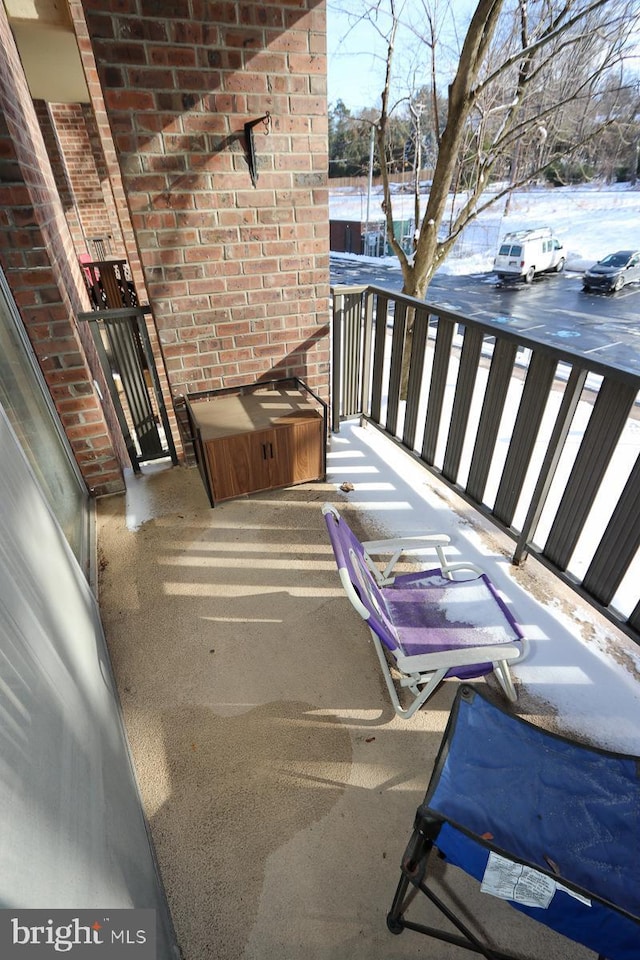 view of snow covered back of property