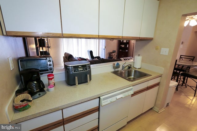 kitchen with light hardwood / wood-style floors, dishwasher, sink, and white cabinets