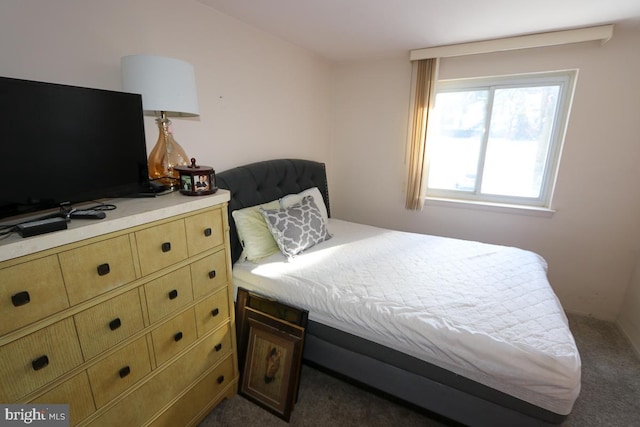 bedroom featuring dark carpet