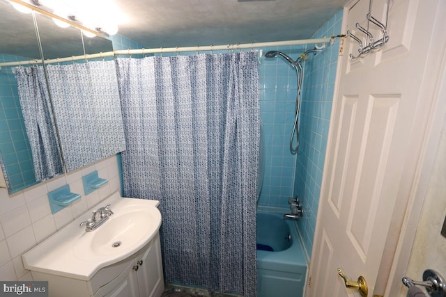 bathroom with tile walls, vanity, decorative backsplash, and shower / tub combo with curtain