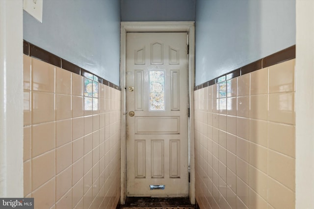 doorway featuring tile walls