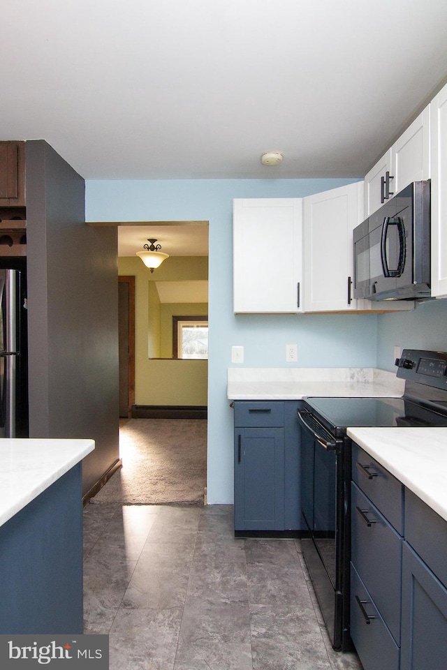 kitchen with white cabinetry, blue cabinetry, and black appliances