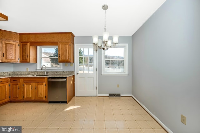 kitchen featuring sink, a chandelier, hanging light fixtures, dishwasher, and light stone countertops