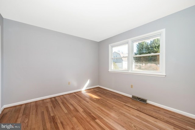 spare room featuring light wood-type flooring