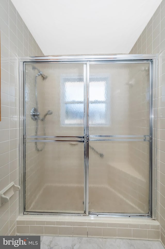 bathroom featuring an enclosed shower