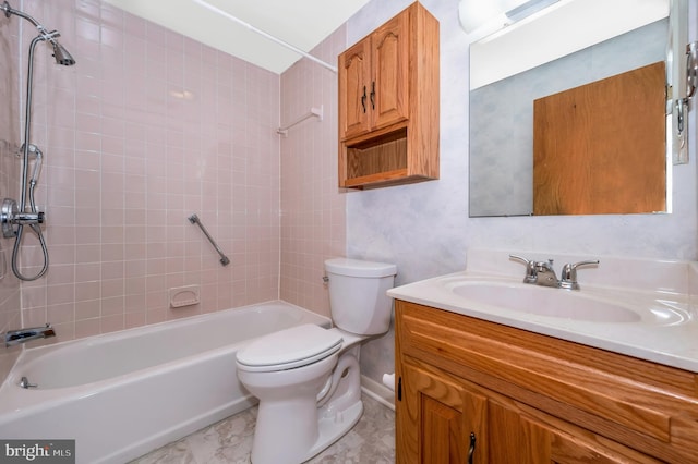 full bathroom with tiled shower / bath combo, vanity, and toilet