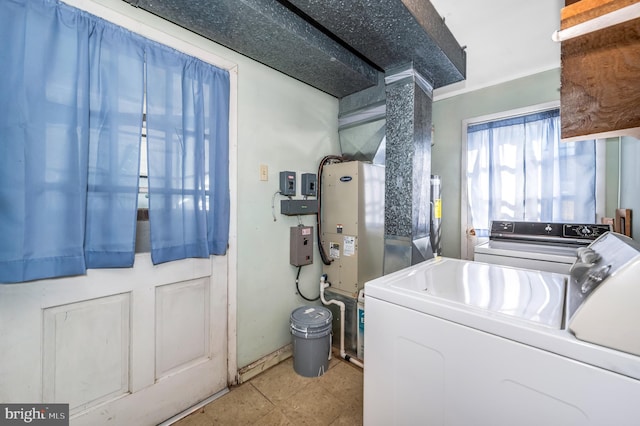 laundry area featuring light tile patterned flooring and separate washer and dryer