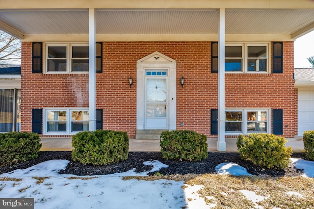 view of snow covered property entrance