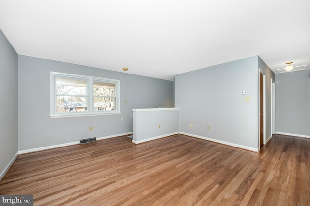 spare room featuring light hardwood / wood-style flooring