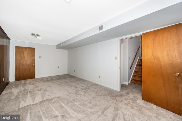 basement featuring light colored carpet