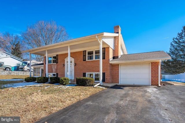 split foyer home with a garage and a porch