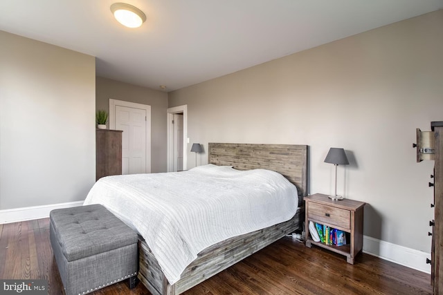 bedroom with baseboards and wood finished floors