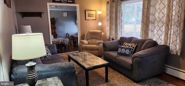 living area with a baseboard radiator and wood finished floors