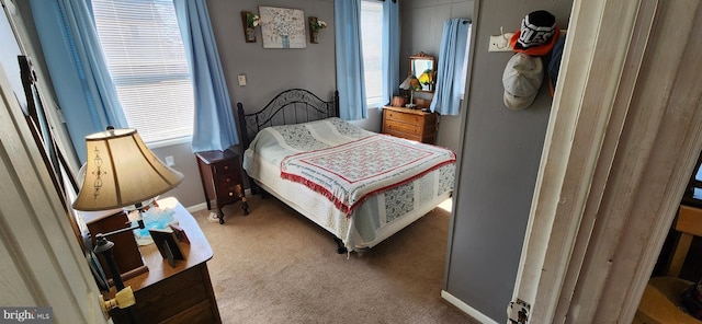 carpeted bedroom featuring baseboards