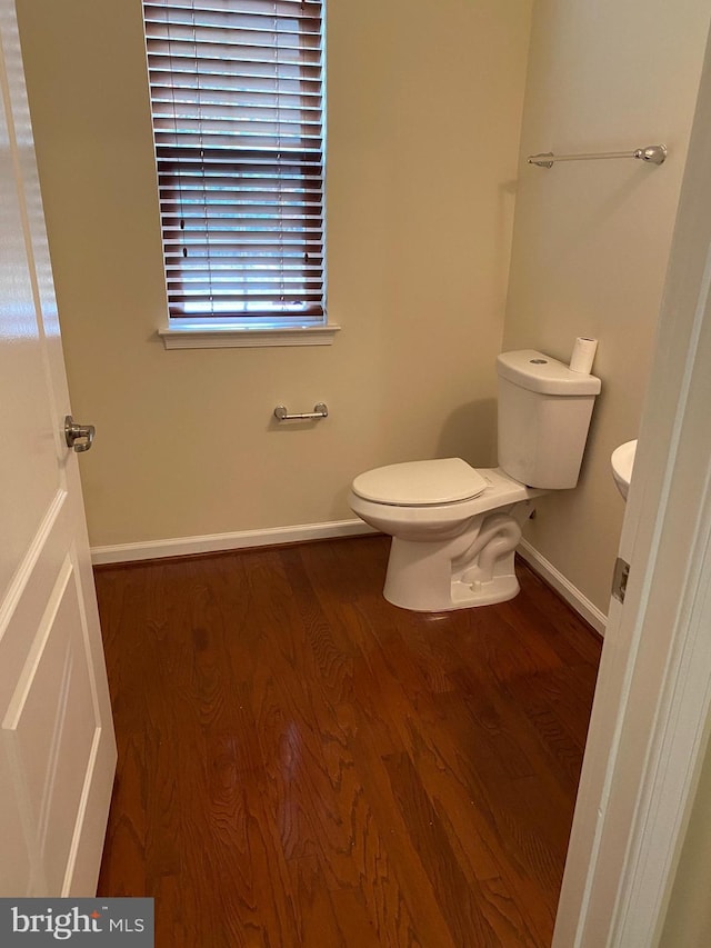 bathroom featuring hardwood / wood-style flooring and toilet