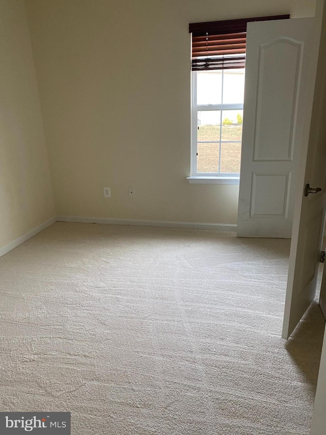 empty room with light colored carpet