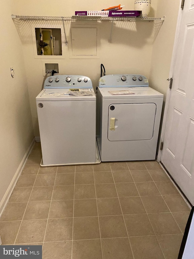 washroom featuring tile patterned floors and washer and clothes dryer