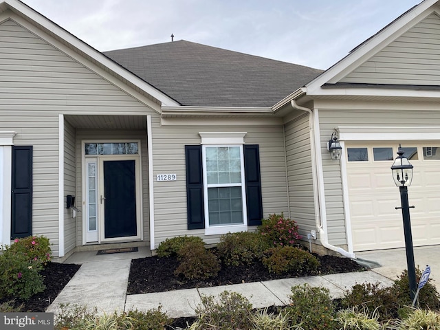 view of exterior entry with a garage