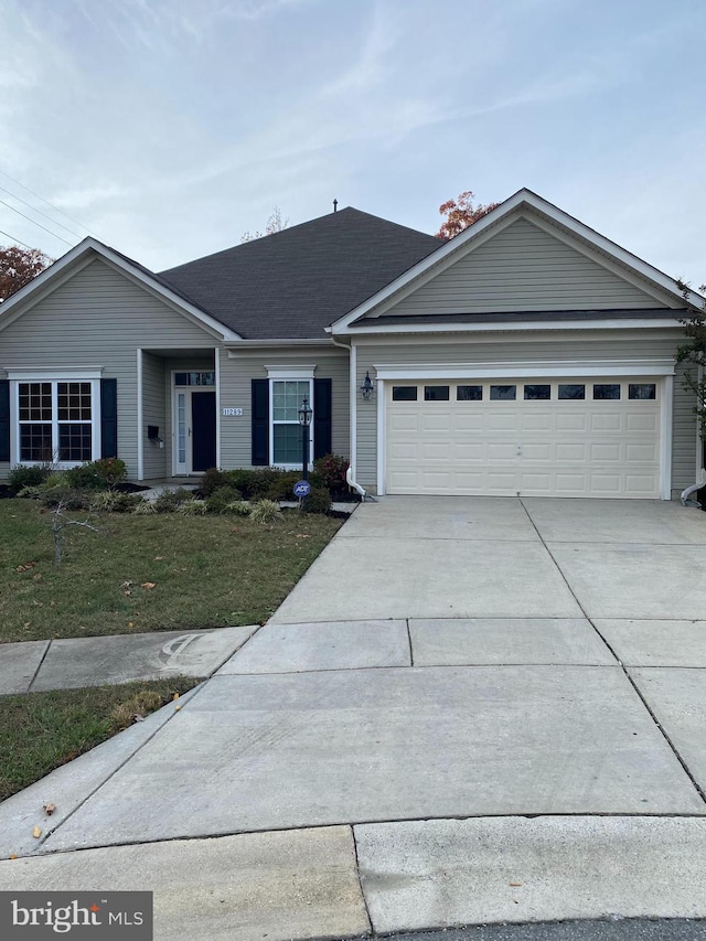 ranch-style house with a garage and a front lawn