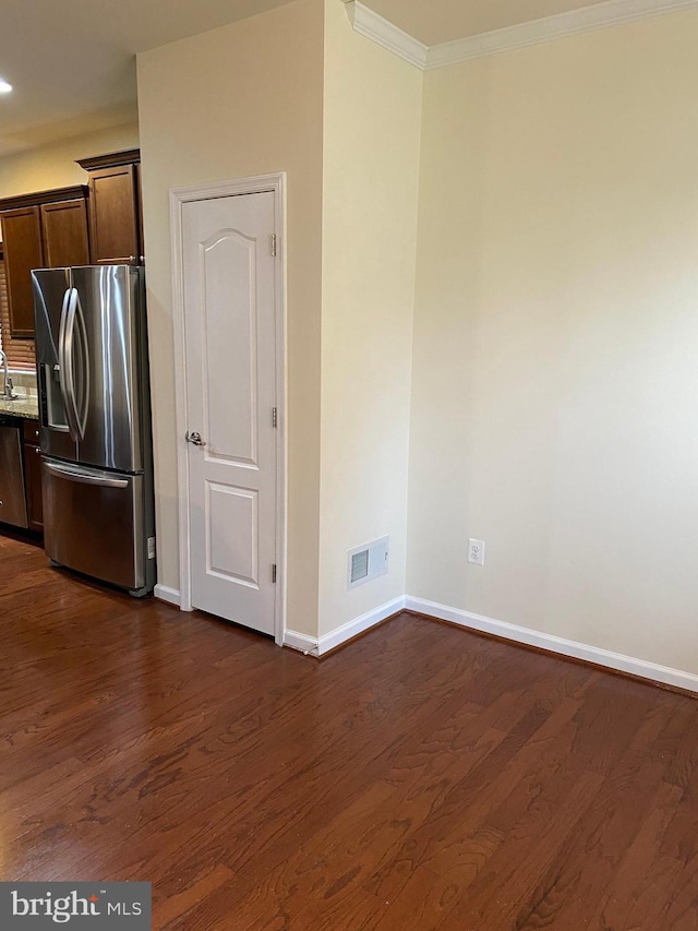 kitchen featuring stainless steel appliances, dark hardwood / wood-style floors, light stone countertops, and dark brown cabinets