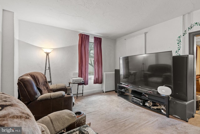 carpeted living room featuring radiator heating unit and a textured ceiling