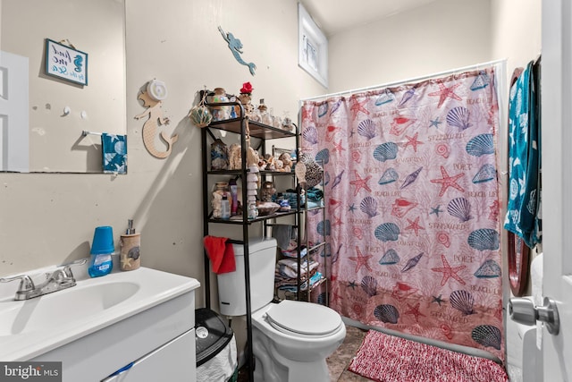 bathroom featuring vanity, curtained shower, and toilet