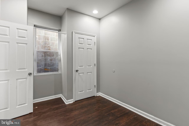 hall with dark wood-type flooring