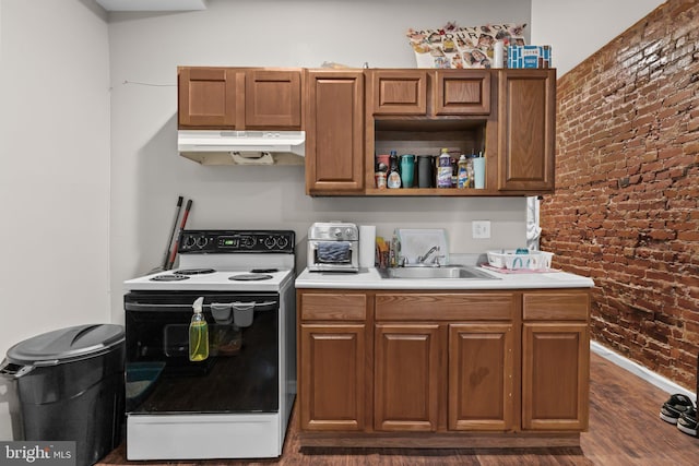 kitchen with range with electric cooktop, brick wall, dark wood-type flooring, and sink