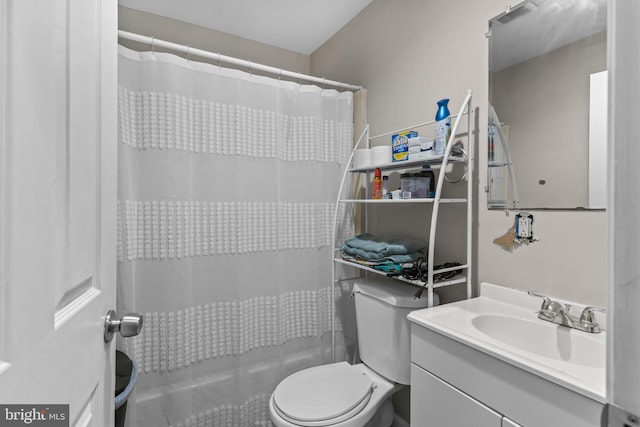 bathroom featuring vanity, a shower with shower curtain, and toilet