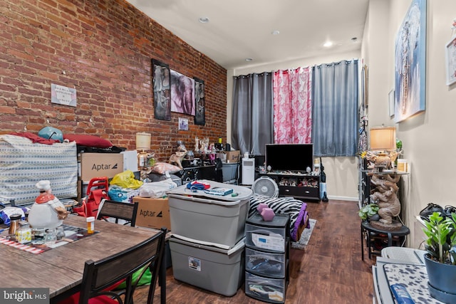 office area featuring brick wall and dark wood-type flooring