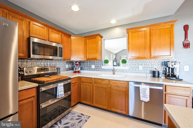 kitchen featuring sink, backsplash, and appliances with stainless steel finishes