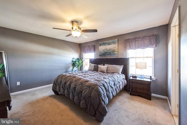 bedroom featuring light carpet and ceiling fan