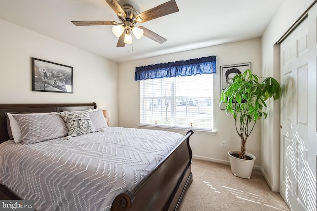 carpeted bedroom featuring a closet and ceiling fan