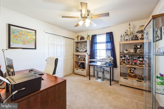 carpeted office featuring ceiling fan