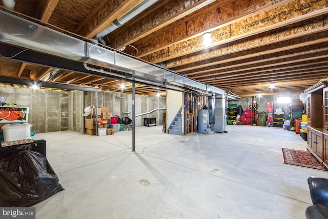 basement featuring gas water heater and heating unit