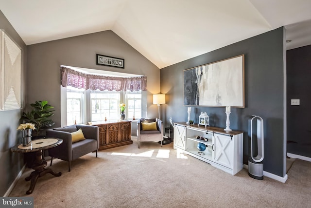 sitting room with lofted ceiling and light carpet