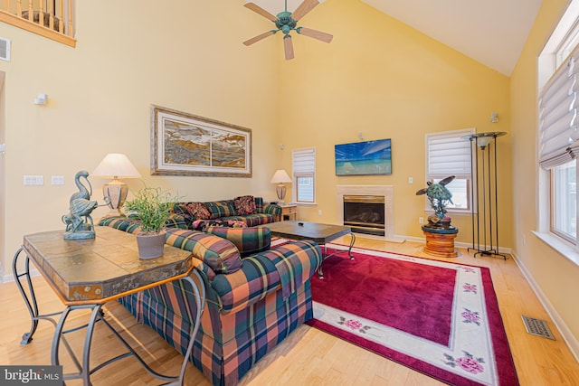 living room with ceiling fan, high vaulted ceiling, and hardwood / wood-style floors