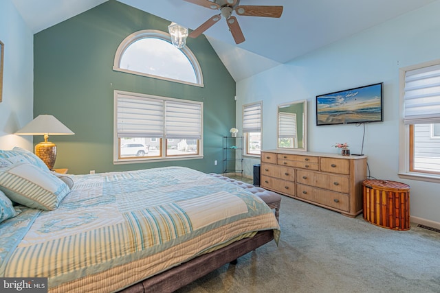 carpeted bedroom with high vaulted ceiling and ceiling fan