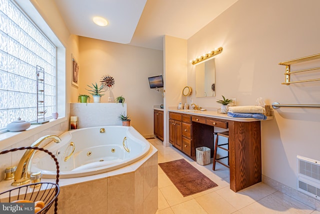 bathroom with vanity, tile patterned flooring, heating unit, and tiled bath