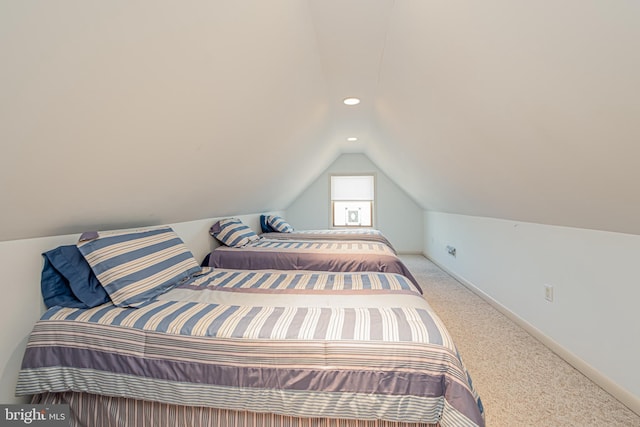 carpeted bedroom with lofted ceiling