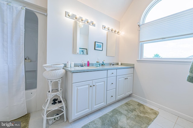 bathroom featuring vaulted ceiling, vanity, tile patterned floors, and shower / tub combo with curtain