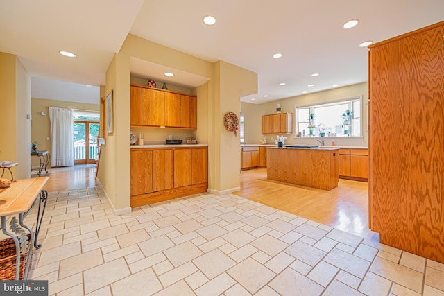 kitchen featuring a healthy amount of sunlight, sink, and a kitchen island